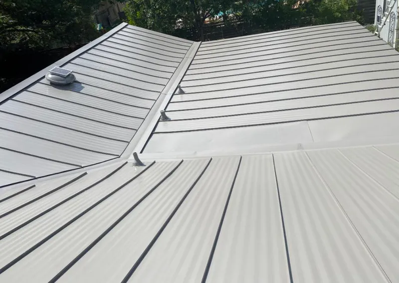 Solar attic fan installed on a metal roof for Roof Ventilation in Urbandale