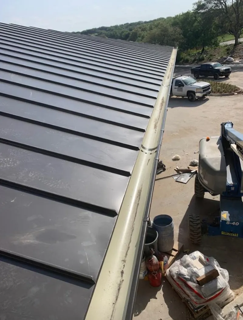 Standing seam panel and gutter detail on a metal roofing jobsite in Urbandale